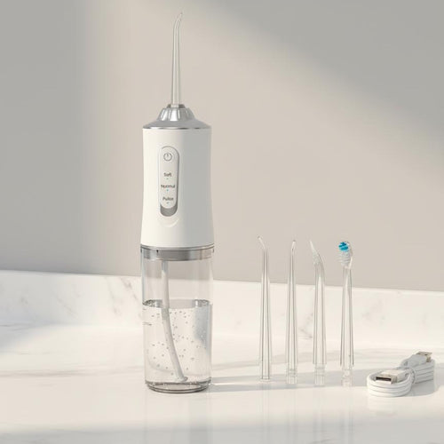 White Flossify cordless water flosser with 4 nozzles and USB cable